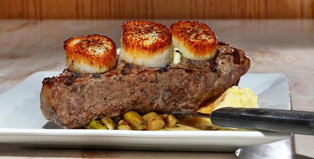 Steak and scallops plated at the Community Restaurant